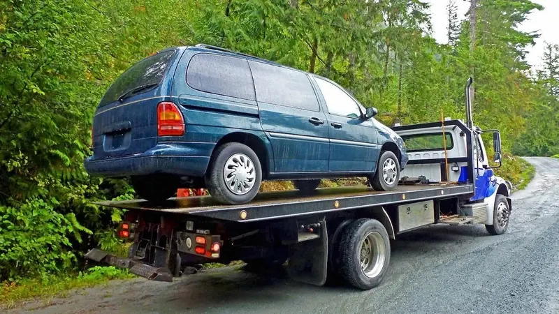Abbotsford flatbed towing a cargo van