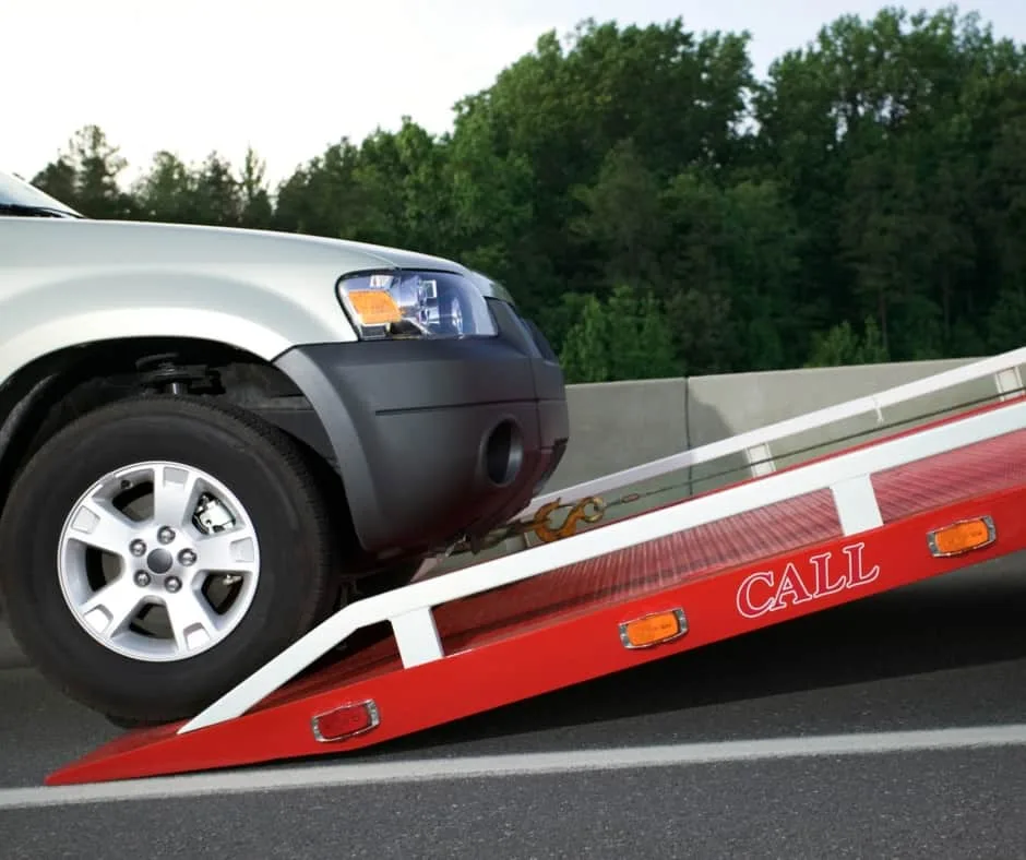 Abbotsford tow truck loading a vehicle on a residential street